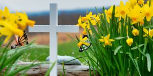 photos of a cross with yellow flowers